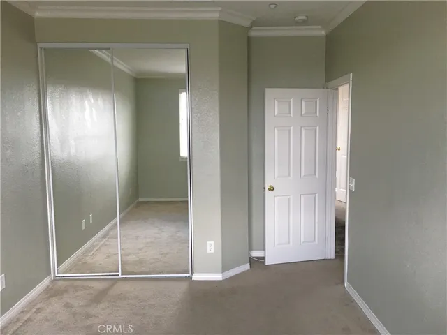 an empty room with fan and entrance