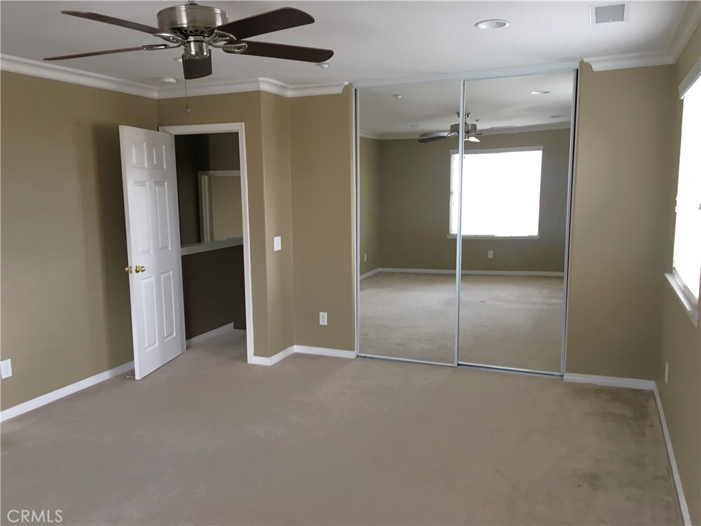 15213 Hawk Street Fontana, CA 92336 - Photo 18 of 20 an empty room with fan and entrance
