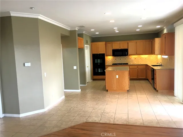 a kitchen with a refrigerator and a sink