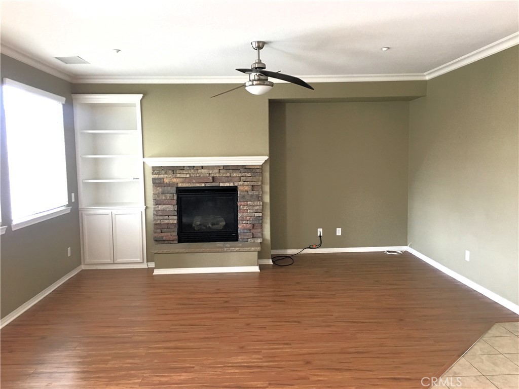 15213 Hawk Street Fontana, CA 92336 - Photo 4 of 20 a view of an empty room with a fireplace and a window