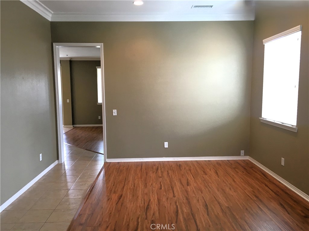 15213 Hawk Street Fontana, CA 92336 - Photo 5 of 20 wooden floor in an empty room with a window