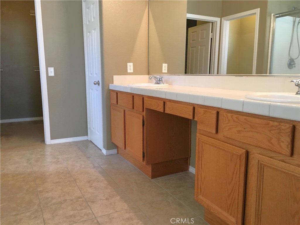 15213 Hawk Street Fontana, CA 92336 - Photo 9 of 20 a bathroom with a sink and a mirror