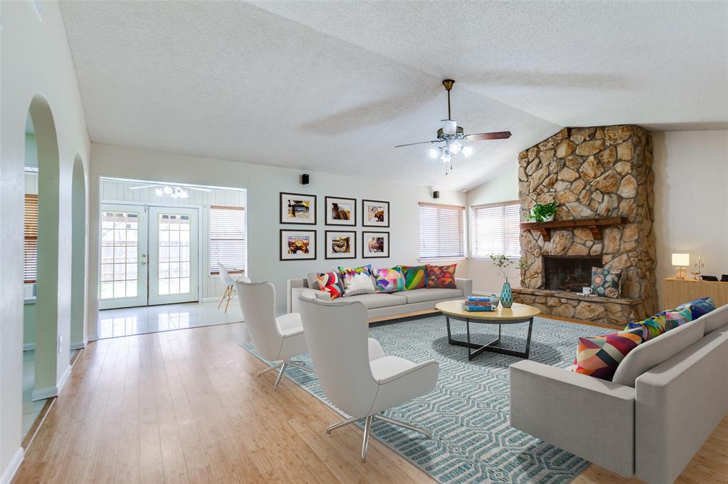 1704 Crystal Way Plano, TX 75074 - Photo 1 of 1 Living area with ceiling fan, vaulted ceiling, wood finished floors, arched walkways, and a textured ceiling