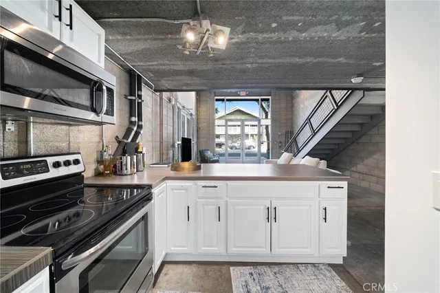 a kitchen with stainless steel appliances granite countertop a stove and cabinets
