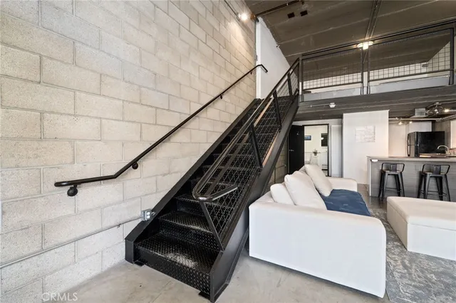 a living room with furniture and stairs