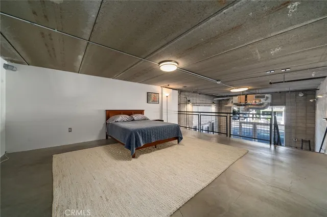 a room with a bed and a large window