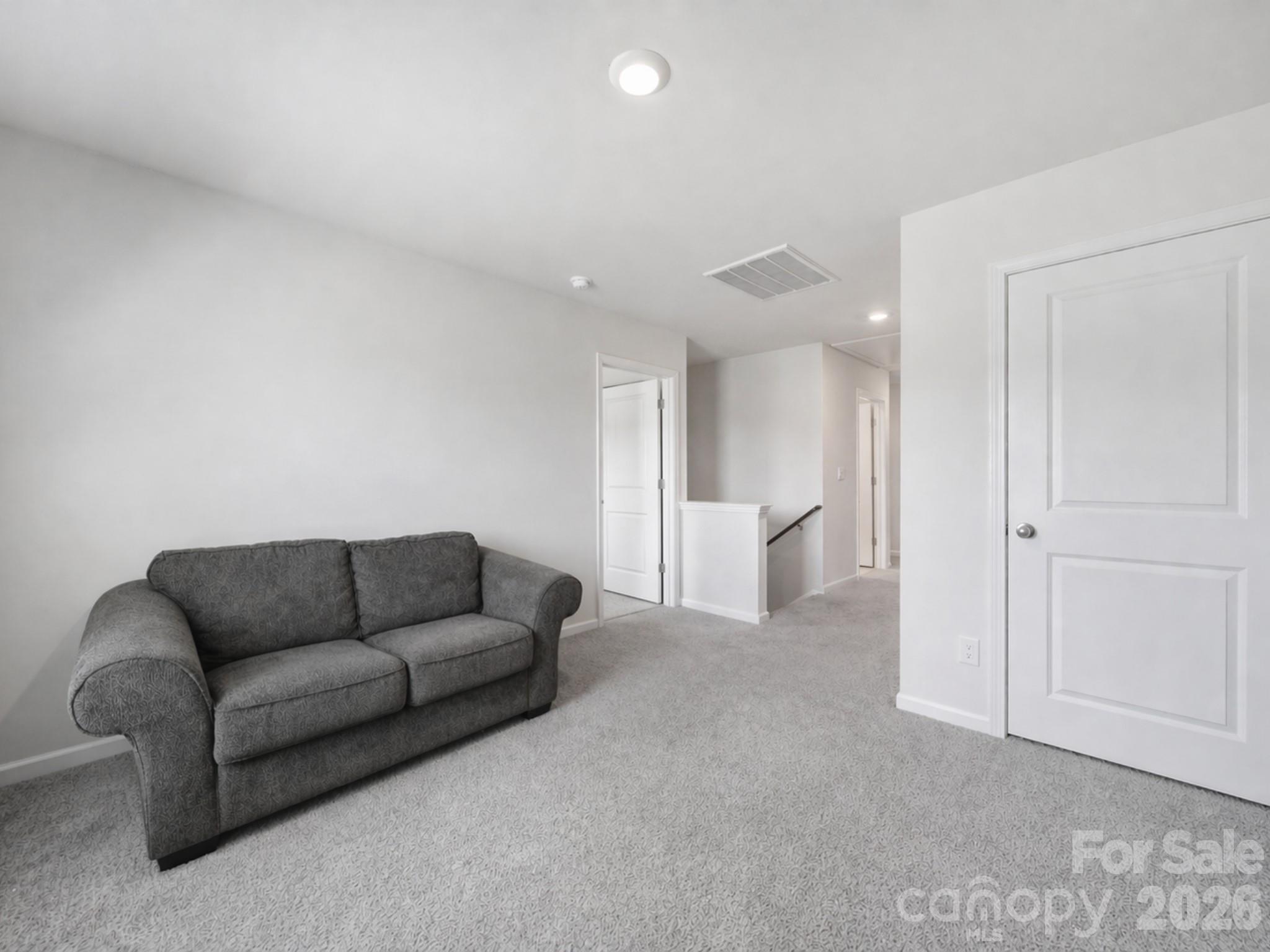 107 Spring Hall Court Troutman, NC 28166 - Photo 23 of 28 a living room with furniture and white walls