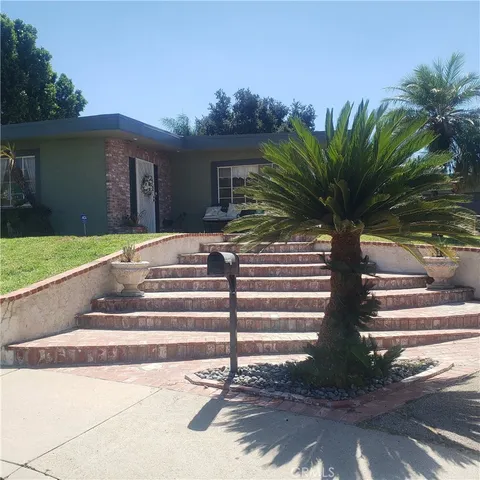 a front view of a house with a yard and a garage