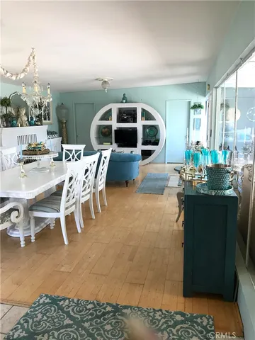 a dining room with furniture and a floor to ceiling window