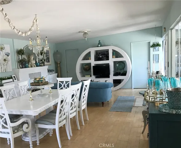 a view of a dining room with furniture and chandelier
