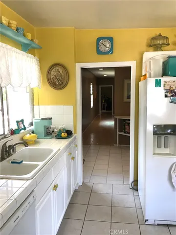 a kitchen with a sink and a refrigerator