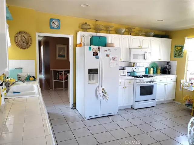 a kitchen with stainless steel appliances a refrigerator sink and cabinets