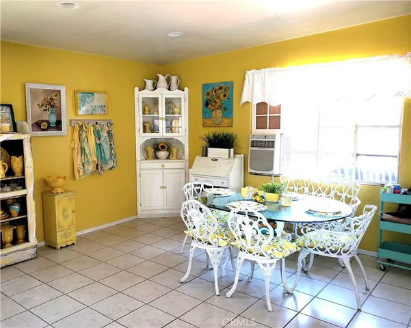 a dining room with furniture and window