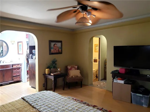 a bedroom with a bed and a chandelier