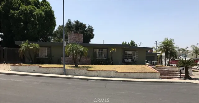 a view of street with yellow house