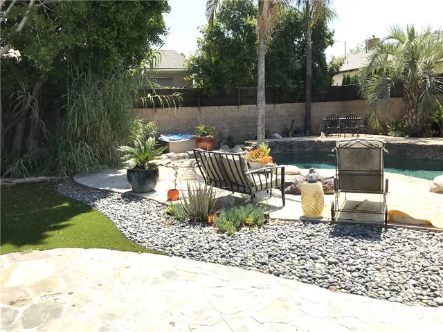 a view of a backyard with sitting area
