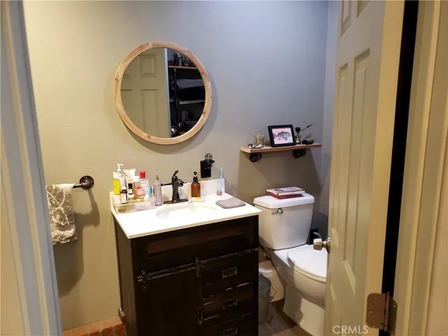 a bathroom with a sink toilet and a mirror