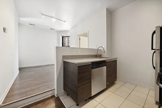 a kitchen with stainless steel appliances granite countertop a sink and a stove