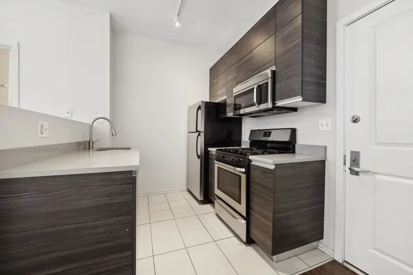a kitchen with stainless steel appliances granite countertop a sink and a stove