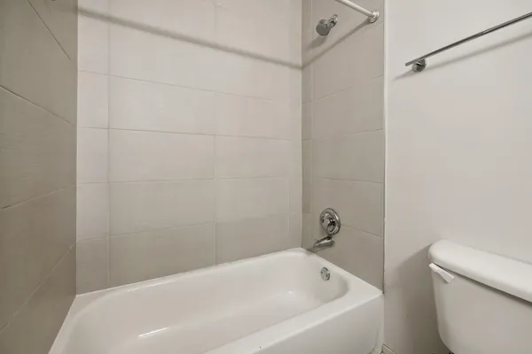 a bathroom with a white bath tub and a shower