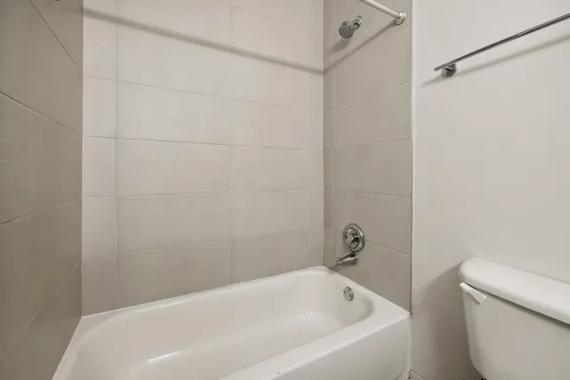 a bathroom with a white bath tub and a shower