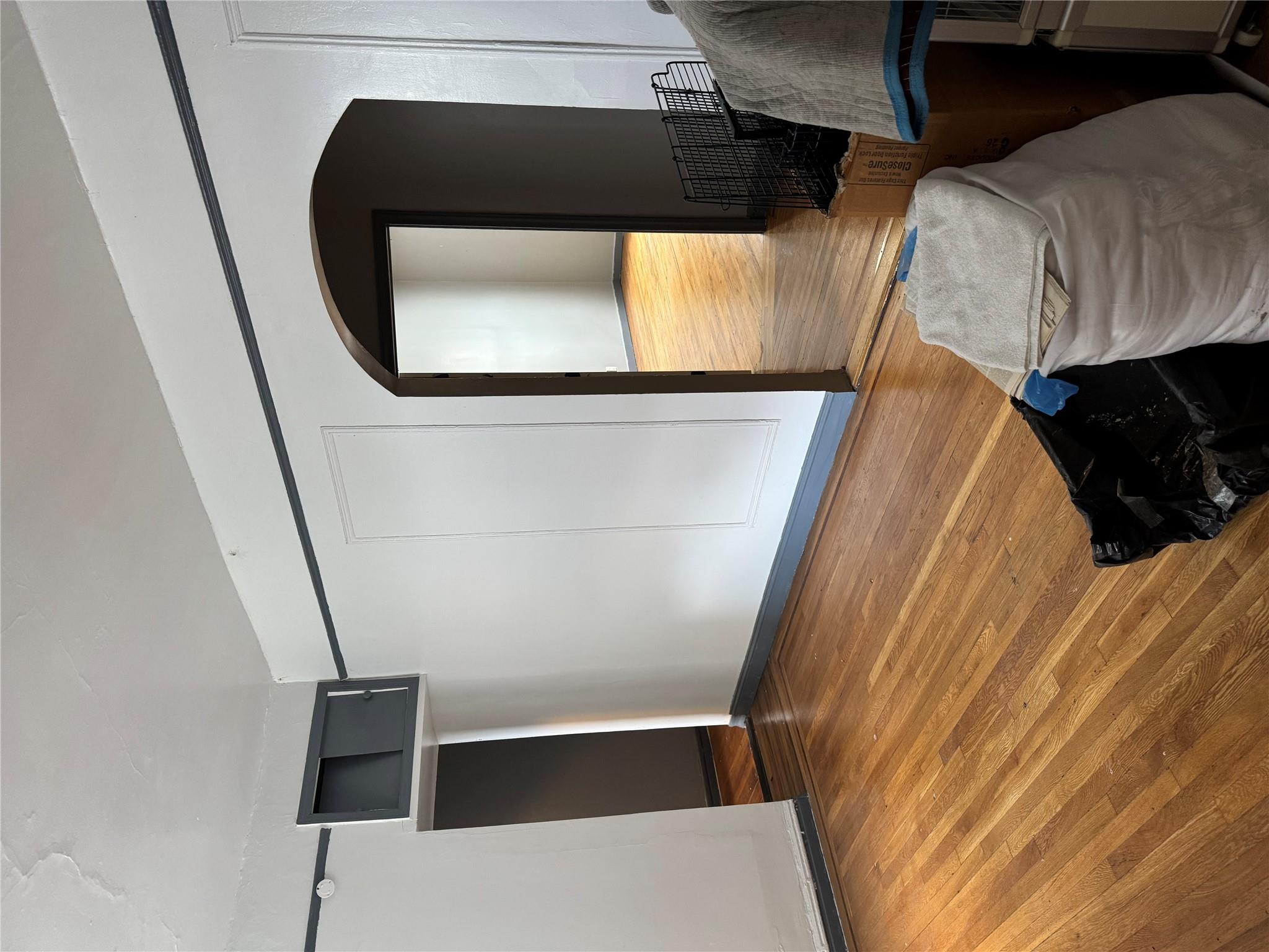 2922 Barnes Avenue, Unit 3A Bronx, NY 10467 - Photo 4 of 12 Unfurnished bedroom with arched walkways and wood finished floors