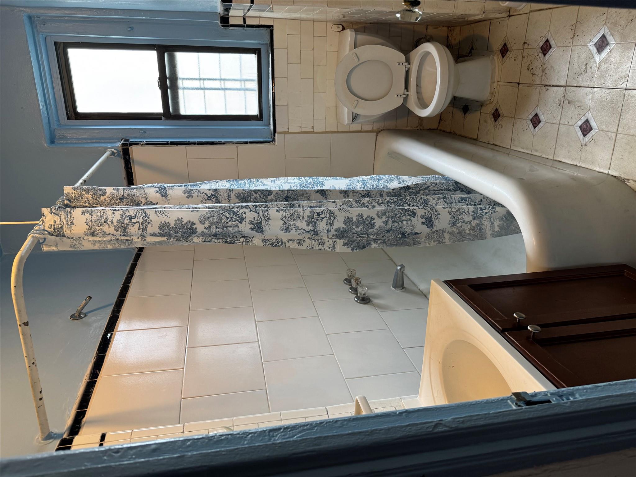 2922 Barnes Avenue, Unit 3A Bronx, NY 10467 - Photo 6 of 12 Bathroom with tile walls, shower / bath combination with curtain, tile patterned flooring, and vanity