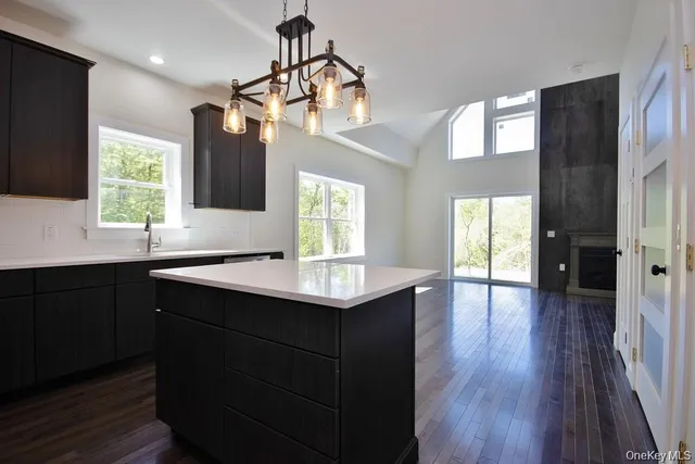 a kitchen with sink cabinets and wooden floor