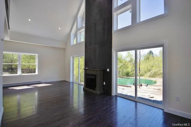 a view of an entryway with wooden floor and windows