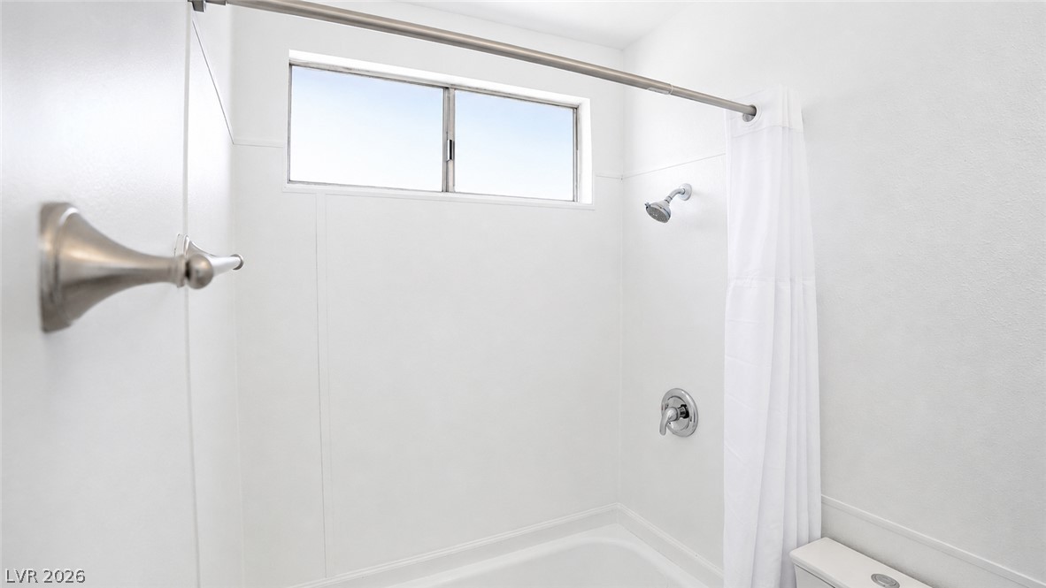 2870 South Sandhill Road Las Vegas, NV 89121 - Photo 53 of 64 A well-appointed bathroom features a bathtub with an overhead window, offering natural illumination.