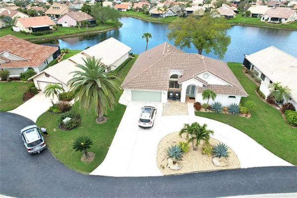 an aerial view of a house with outdoor space and lake view