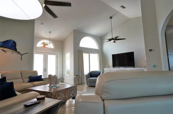 a living room with furniture and a floor to ceiling window