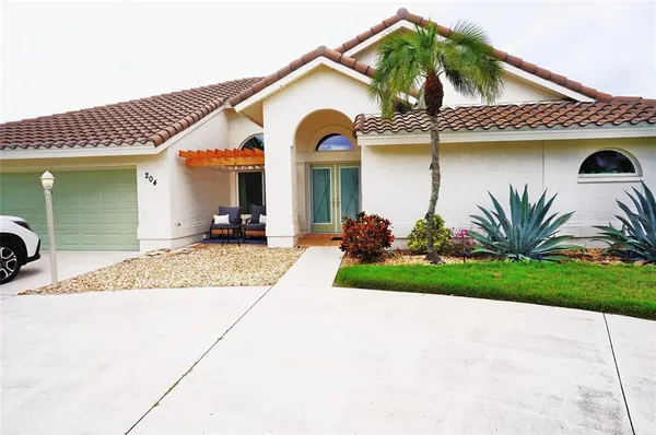 a living room with furniture a fireplace and a chandelier