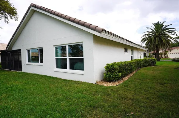 a bathroom with a granite countertop toilet sink and mirror