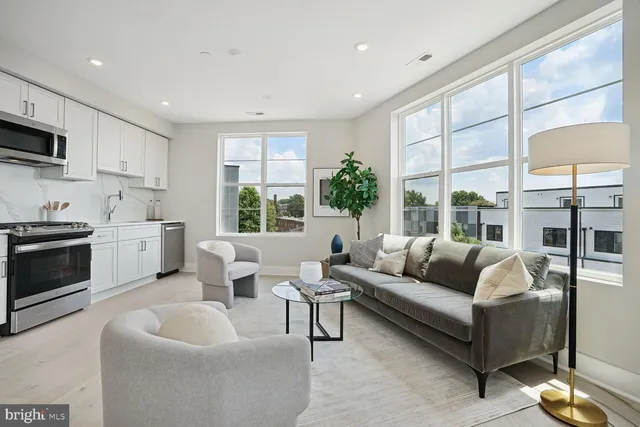 a living room with furniture and a large window