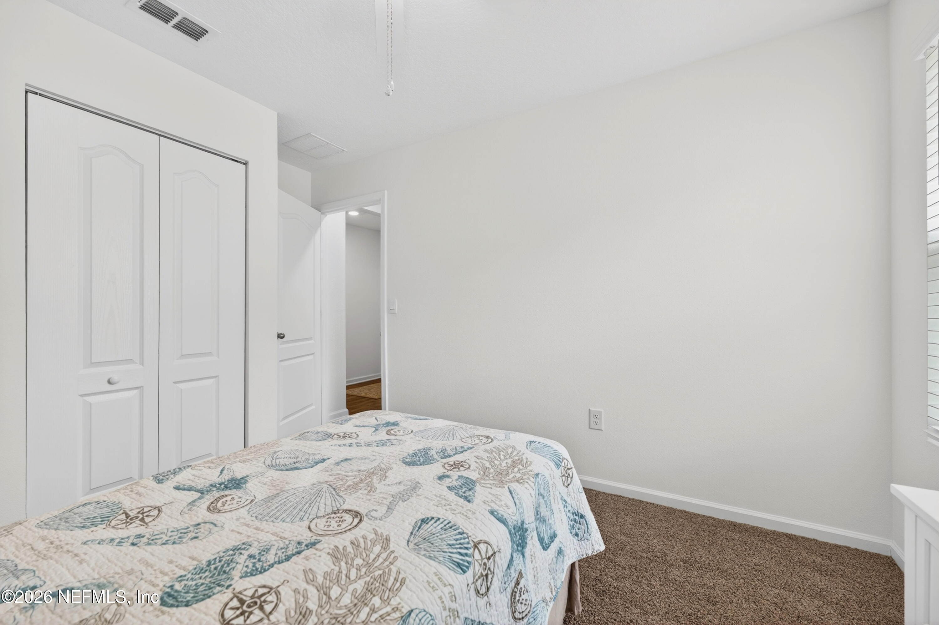 231 Encanto Way Street St. Augustine, FL 32084 - Photo 17 of 36 a bedroom with a bed and a window