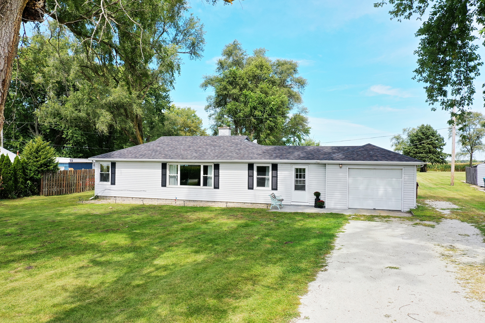 a front view of a house with yard patio and green space