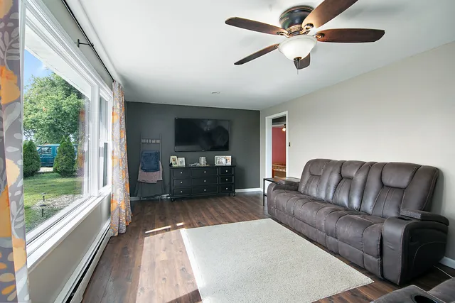 a living room with furniture fireplace and a large window