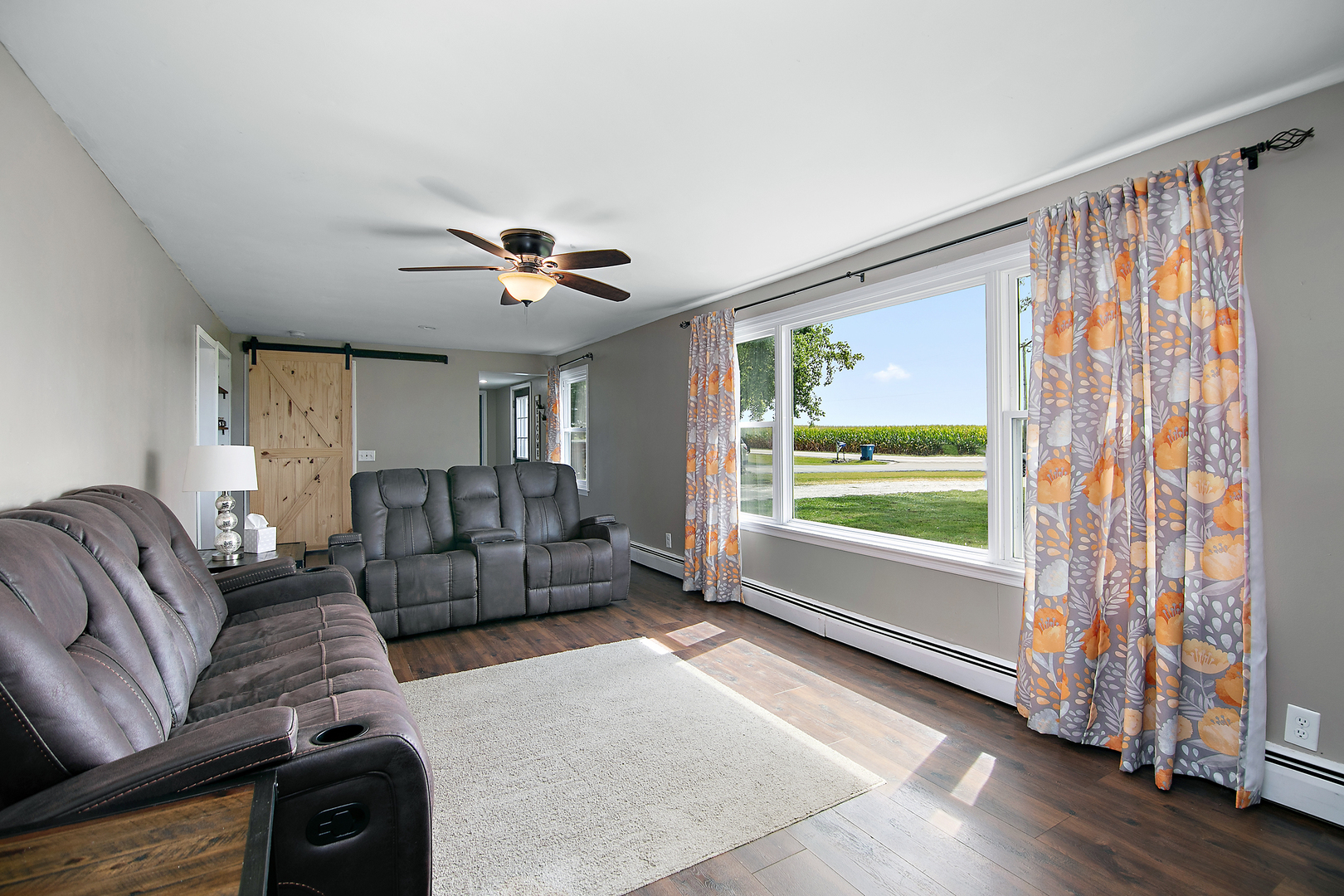 1627 West 2000S Road Kankakee, IL 60901 - Photo 13 of 30 a living room with furniture and a large window with wooden floor