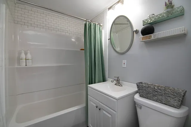 a bathroom with a sink a toilet and a mirror