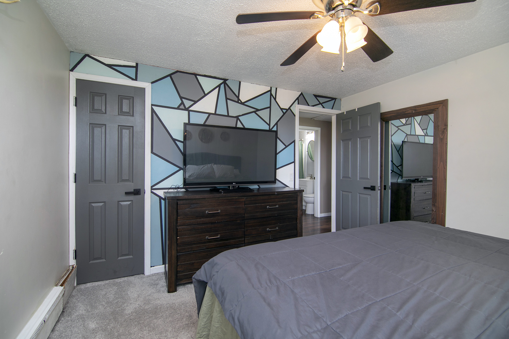 1627 West 2000S Road Kankakee, IL 60901 - Photo 24 of 30 a bedroom with a bed and a flat tv screen on dresser