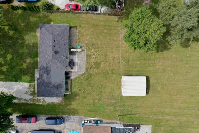 an aerial view of a house with a yard