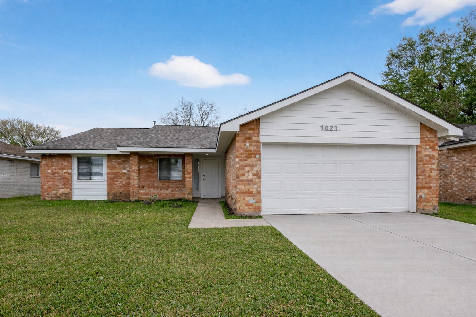 7027 Dickson Way Missouri City, TX 77489 - Photo 1 of 22 This photo shows a charming single-story brick home with a well-maintained lawn and a two-car garage. The exterior features a classic design with a gable roof and a clean driveway leading to the entrance. Ideal for those seeking a cozy and inviting residence.