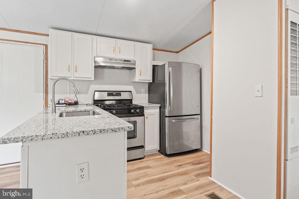 7227 Grand Brooks Road Spotsylvania, VA 22551 - Photo 4 of 47 Modern kitchen with sleek finishes.
