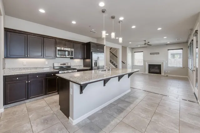 a kitchen with stainless steel appliances granite countertop a sink and cabinets