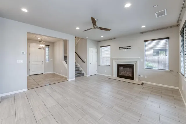 an empty room with windows and a fireplace