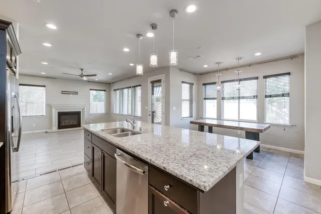 a large kitchen with kitchen island a large counter top and outdoor space