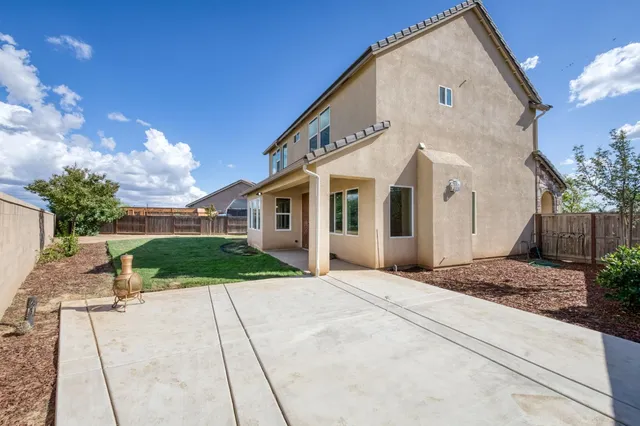 a view of a white house with a yard
