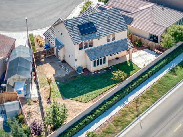 a view of a house with a backyard and balcony