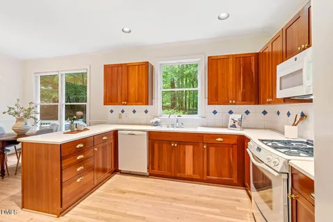 a kitchen with stainless steel appliances granite countertop a sink stove and cabinets